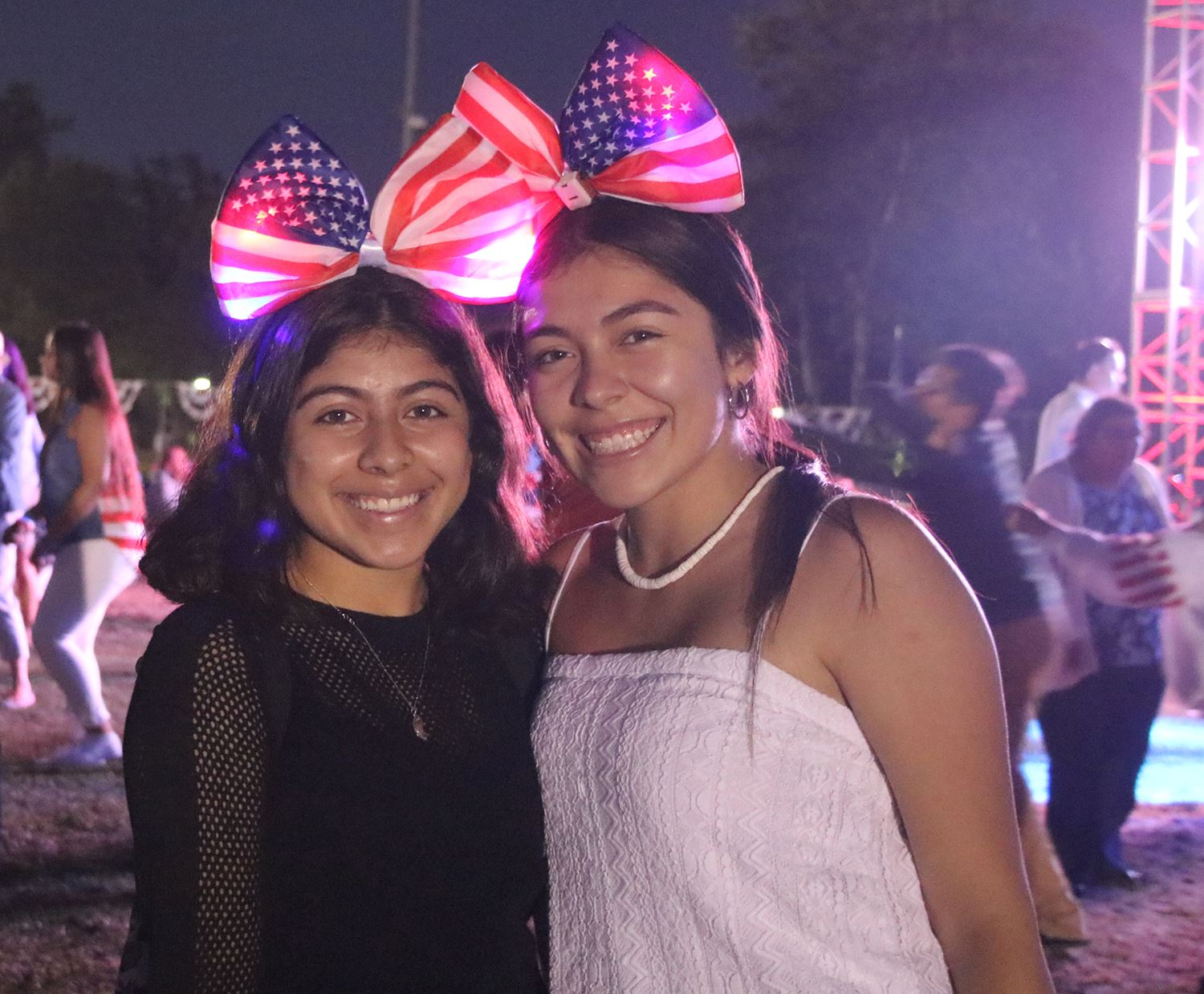 two girls wearing American flag bows